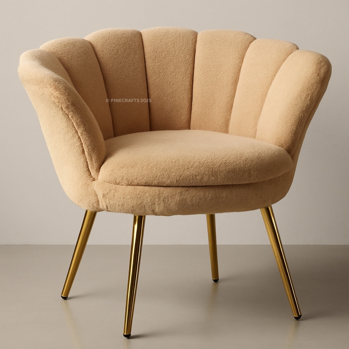 Beige armchair with gold legs on a plain background